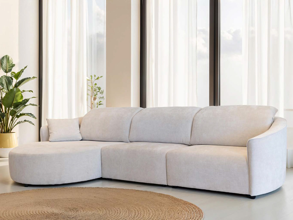 El sofa modular Natalie Round destaca por su chaiselongue redondeada. Personaliza telas y medidas con gran estilo premium