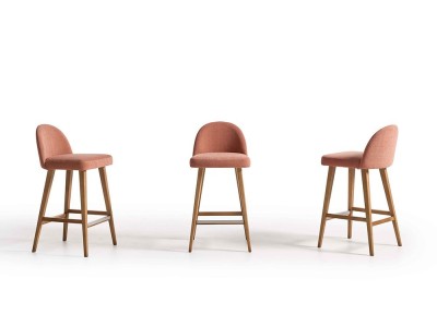 El taburete de diseño 100 de Pérez e Hijos destaca en Seismil Studio, con finas patas de haya y un asiento tapizado suave.